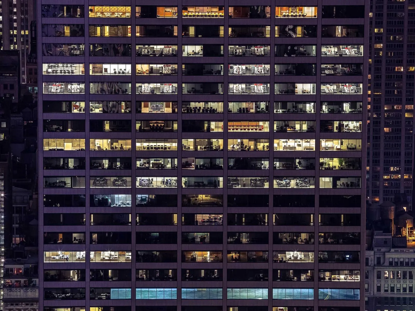 Grid of lit office windows on a high-rise at night